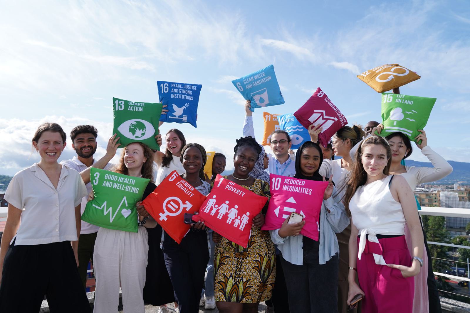 Summer school participants with the Geneva skyline behind them